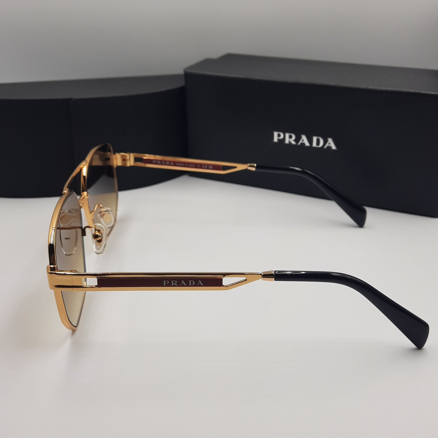 Solaires: PRADA OPS51ZS rouge doré marron deg