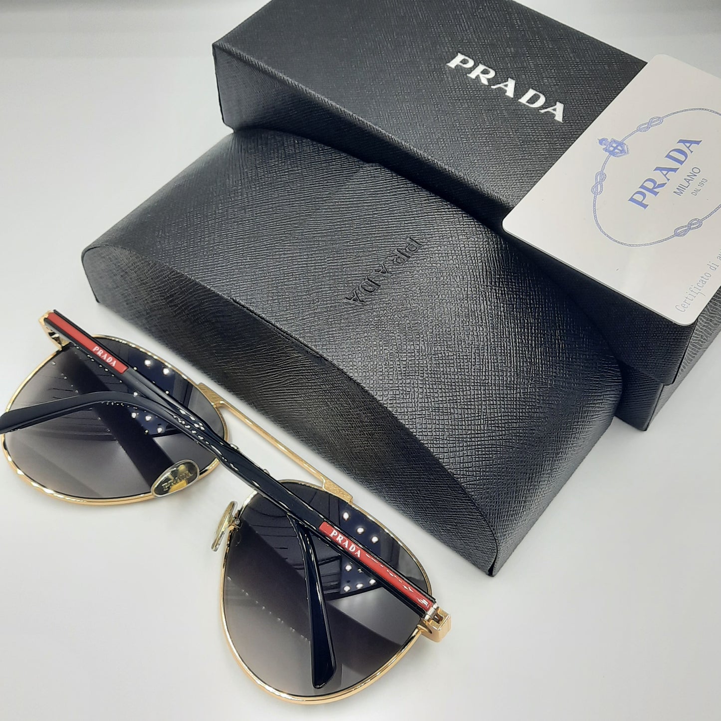 Solaires: PRADA SPRA58 rouge doré noir