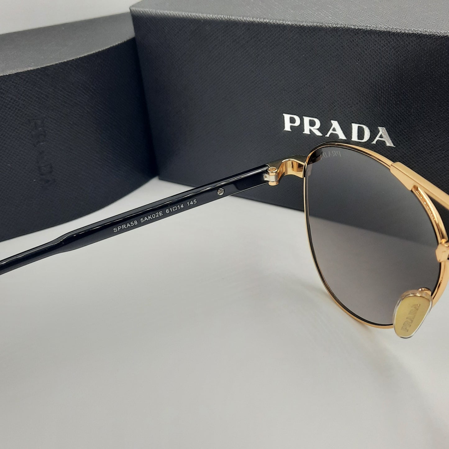 Solaires: PRADA SPRA58 rouge doré noir