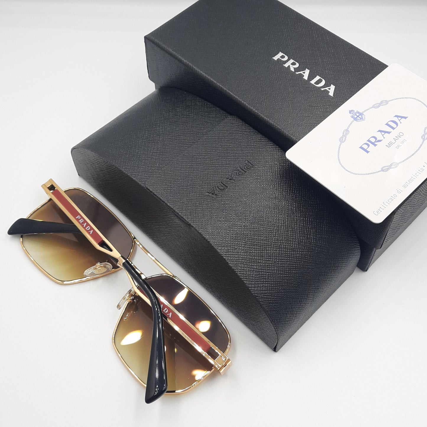 Solaires: PRADA OPS51ZS rouge doré marron deg