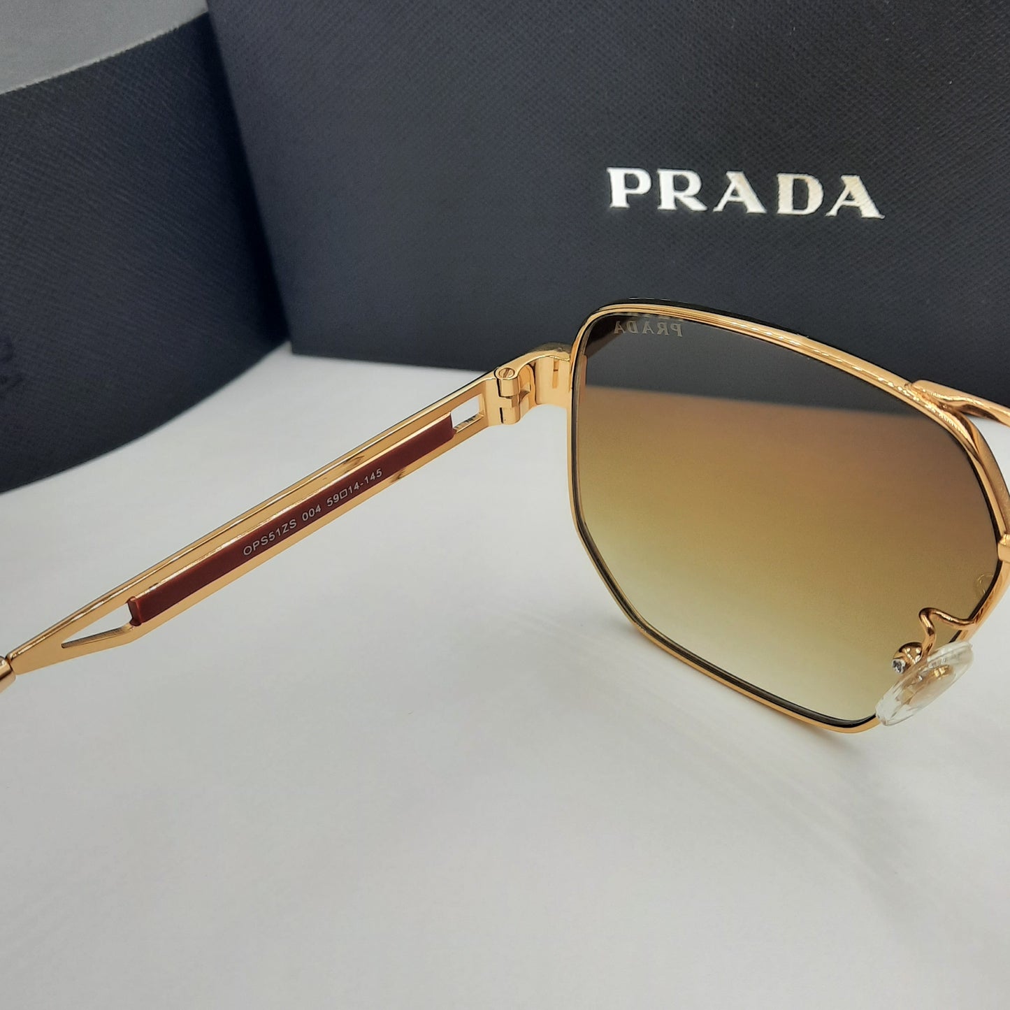 Solaires: PRADA OPS51ZS rouge doré marron deg